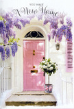 The photograph reveals a softly romantic doorway in Rush Green, perfect for marking the quiet joy of moving into a new place. At the centre stands a pastel-pink front door, its colour gentle and comforting, somewhere between blush and rose, with a smooth finish that glows faintly in the daylight. Draped above and around the door, wisteria spills in generous trails of lavender and lilac, the blooms clustered along long, drooping stems that form a natural, fragrant curtain. The whitewashed wall and a muted pastel shutter add to the composition, their light, neutral tones allowing the floral details to stand out while echoing the airy mood of a calm residential lane near local schools and parks. On the doorstep rests a tin bucket, modest yet stylish, filled to overflowing with white and cream roses. Each rose is fully open, its petals layered and velvety, creating soft domes of texture that seem almost cushion-like, while delicate green foliage snakes between the blooms, offering fresh contrast and structure. A satin pink ribbon is tied carefully around the bucket, its silky surface catching just enough light to draw the eye downward and link the arrangement visually with the pink of the door. Gentle shadows from the overhead wisteria fall across the step, adding depth and a sense of quiet afternoon stillness. The overall feeling is one of tender welcome and hopeful anticipation, as though a local Rush Green florist has just delivered this bouquet to celebrate a house-warming, bringing with it not just flowers, but a wish for happiness, security, and cherished memories in the years ahead.
